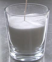 glass with candle sand